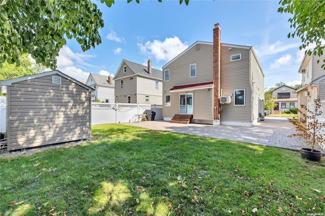 rear view of property featuring a patio area and a yard