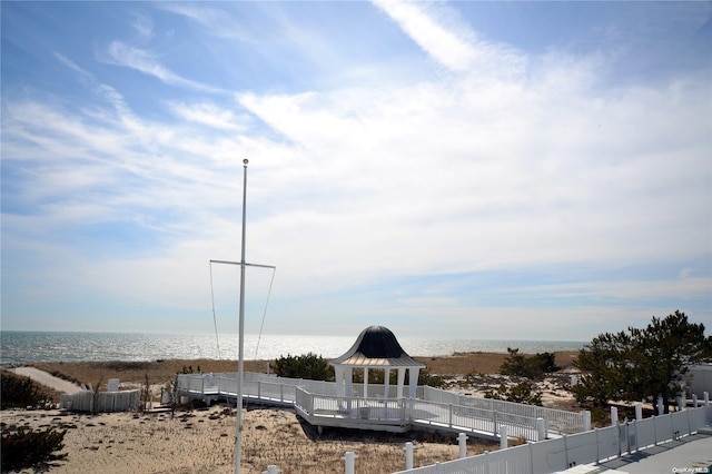 exterior space featuring a gazebo and a water view