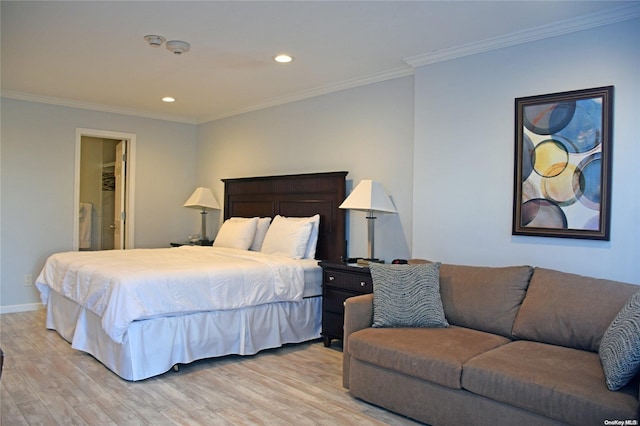 bedroom featuring light wood-type flooring, ensuite bath, and ornamental molding