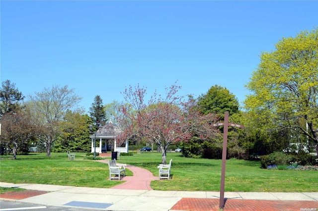 surrounding community featuring a gazebo and a lawn