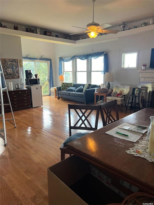 dining area with ceiling fan, plenty of natural light, and hardwood / wood-style flooring