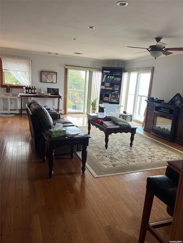 living room featuring ceiling fan, a healthy amount of sunlight, and wood-type flooring