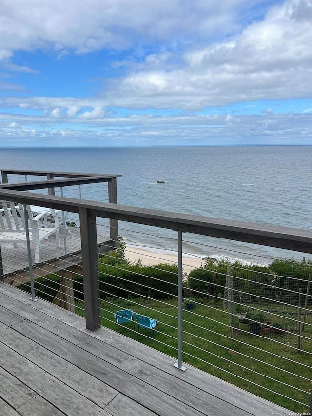 deck with a water view and a beach view