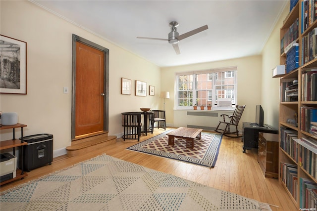 sitting room with radiator heating unit, light hardwood / wood-style flooring, and ceiling fan