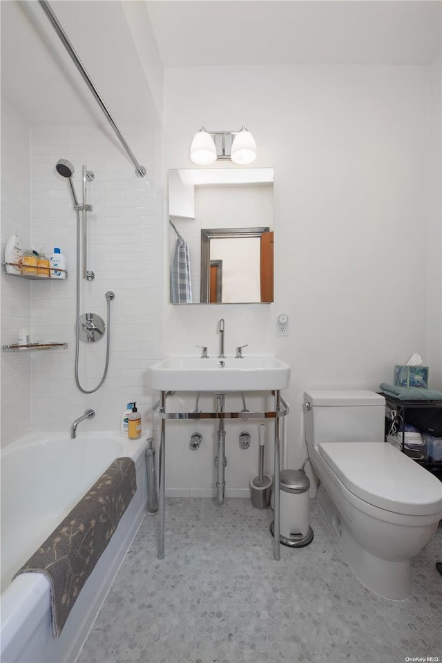 full bathroom with sink, toilet, and tiled shower / bath