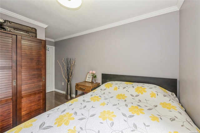 bedroom featuring ornamental molding and dark wood-type flooring