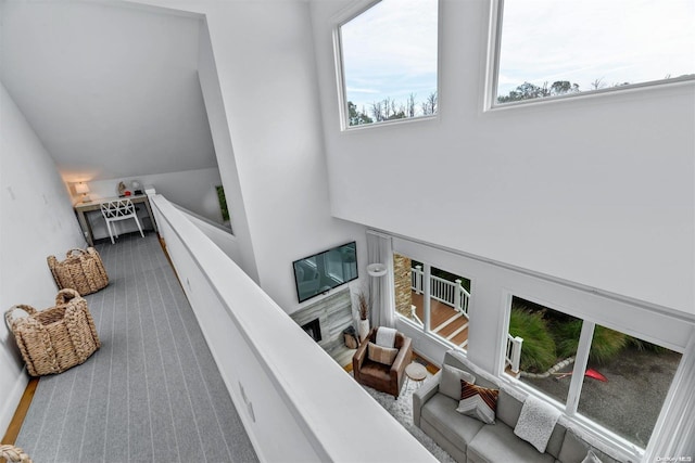 stairs with carpet and a fireplace