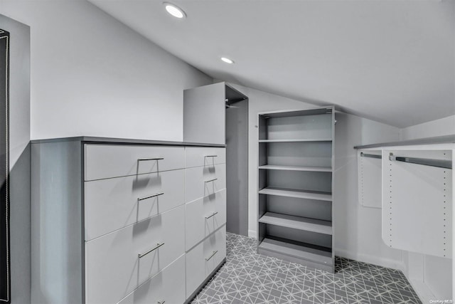 walk in closet with lofted ceiling