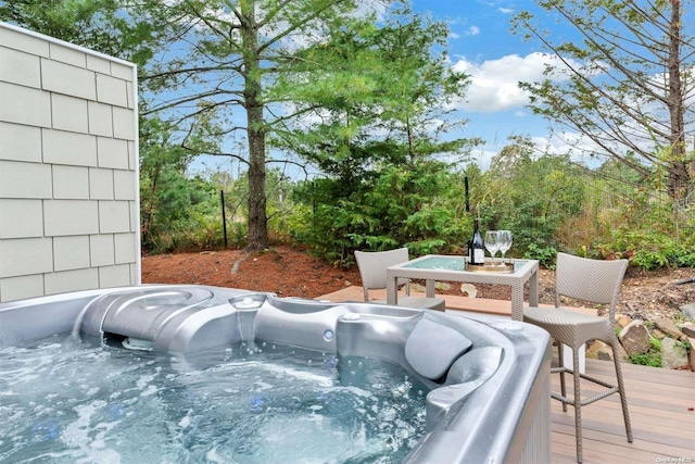 wooden terrace featuring a hot tub