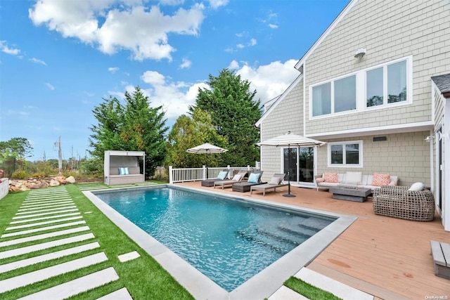 view of swimming pool with an outdoor living space and a deck