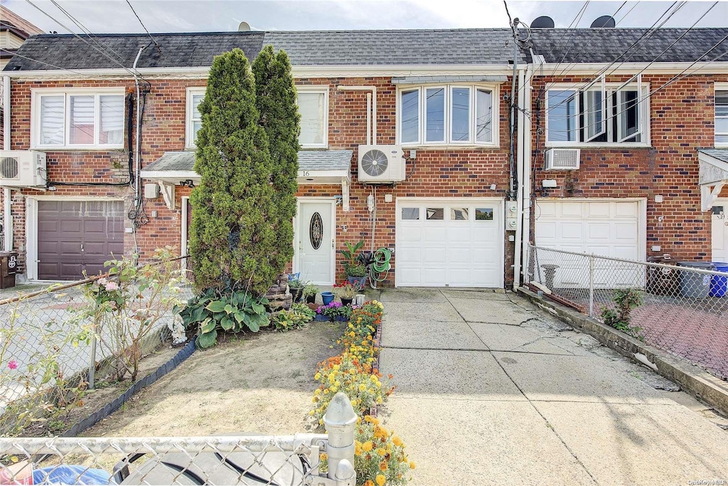 view of front of home with a wall unit AC and ac unit