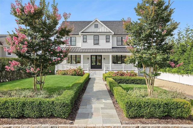 view of front of house with a front yard and a porch