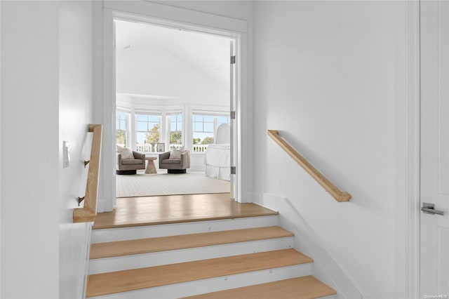 stairway featuring vaulted ceiling