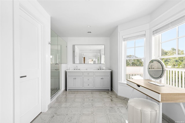 bathroom with vanity and a shower with door