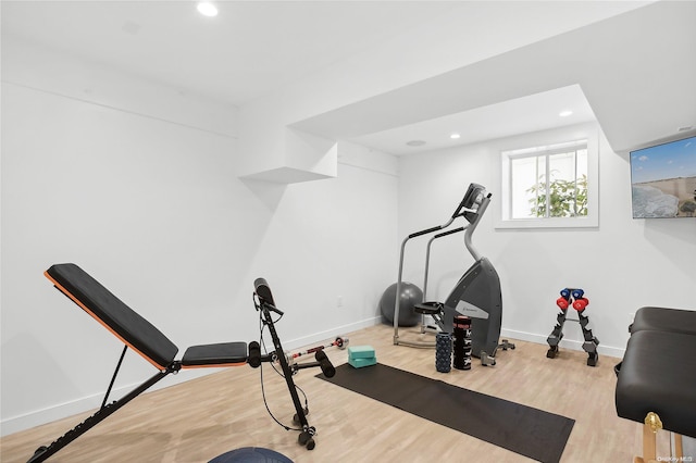 workout room with light hardwood / wood-style flooring