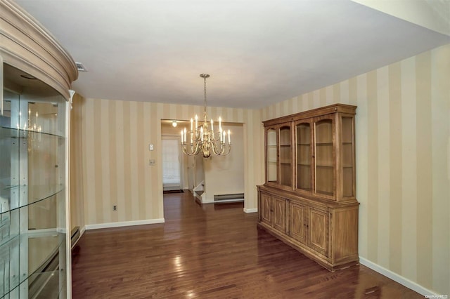 unfurnished dining area featuring dark hardwood / wood-style flooring, a chandelier, and a baseboard radiator