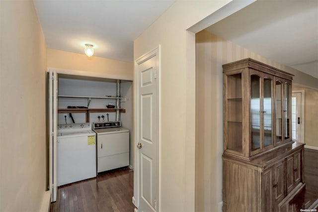 hallway with washer and clothes dryer and dark hardwood / wood-style flooring