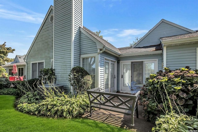 71 Standish Dr Unit 71, Mount Sinai, NY 11766 - back of property with a chimney and a yard