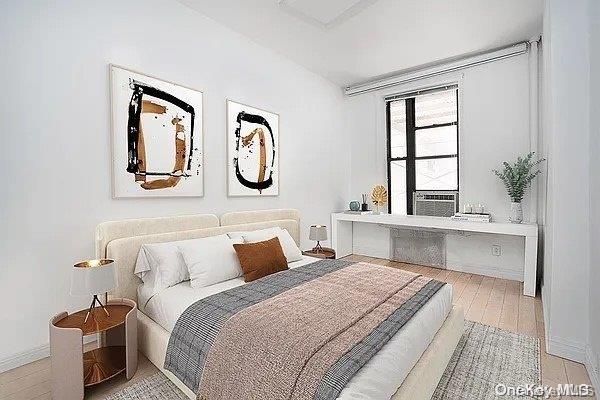 bedroom featuring cooling unit and light hardwood / wood-style floors