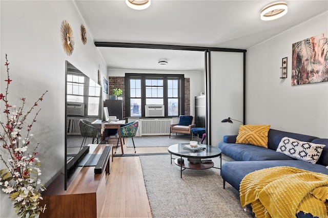 living room featuring radiator heating unit and wood-type flooring