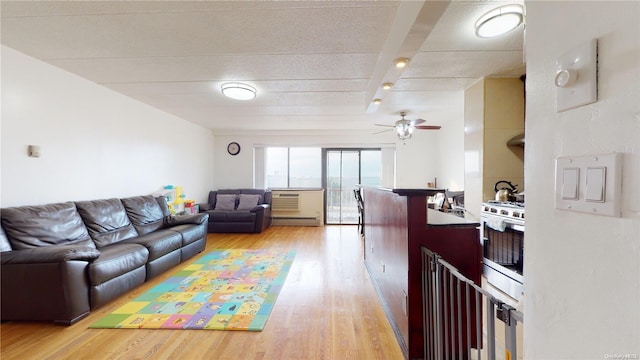 living room featuring ceiling fan and light hardwood / wood-style flooring