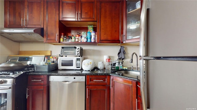 kitchen with stainless steel appliances, extractor fan, and sink