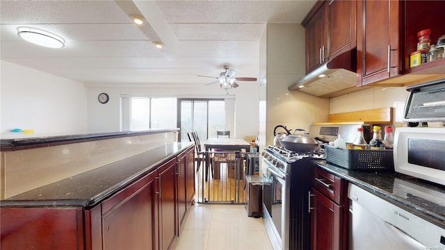 kitchen with beam ceiling, ceiling fan, dark stone counters, white appliances, and light tile patterned floors