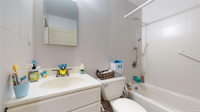 full bathroom with tasteful backsplash, vanity, tiled shower / bath combo, tile walls, and toilet