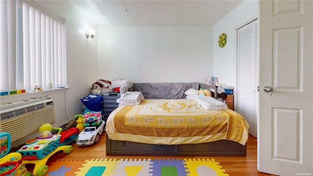 bedroom with hardwood / wood-style floors and a closet