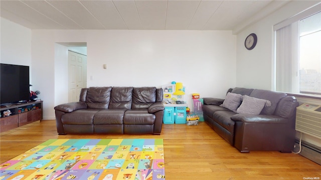 living room featuring baseboard heating and light wood-type flooring