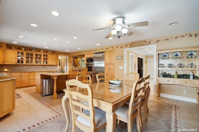 tiled dining area featuring ceiling fan