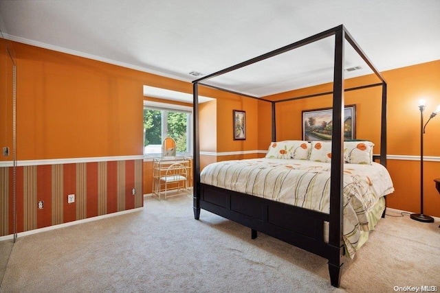 bedroom with carpet floors and crown molding