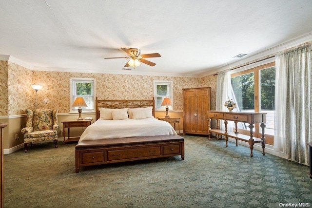 bedroom with ceiling fan, ornamental molding, and dark colored carpet