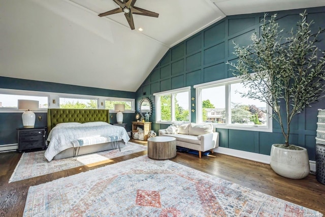 bedroom with dark hardwood / wood-style floors, vaulted ceiling, ceiling fan, and a baseboard heating unit