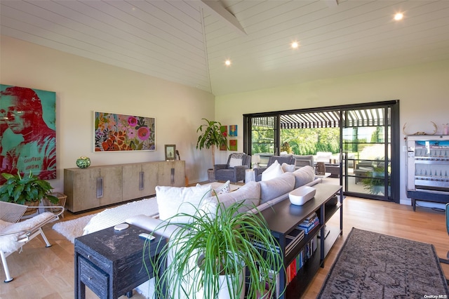 living room with beam ceiling, light hardwood / wood-style floors, and high vaulted ceiling