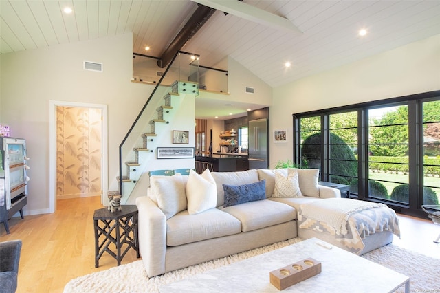 living room featuring wood ceiling, high vaulted ceiling, light hardwood / wood-style floors, and beam ceiling