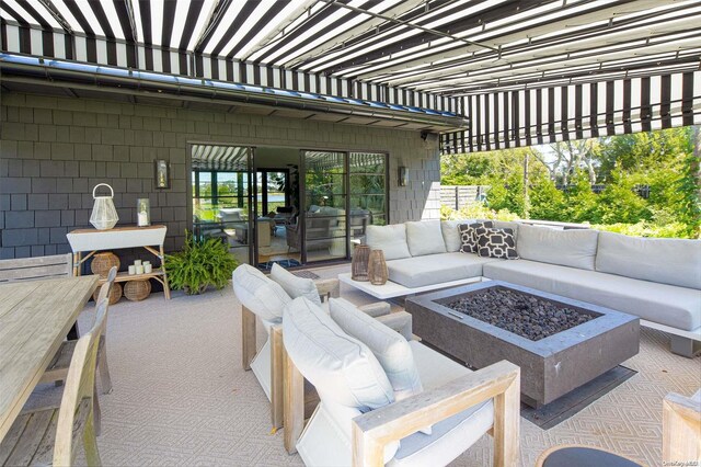 view of patio / terrace featuring an outdoor living space with a fire pit