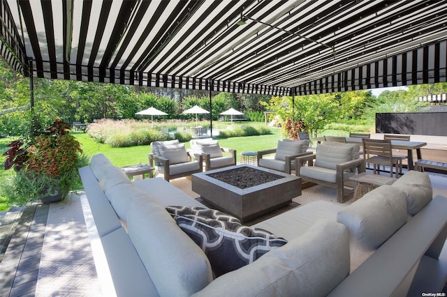 view of patio featuring an outdoor living space with a fire pit