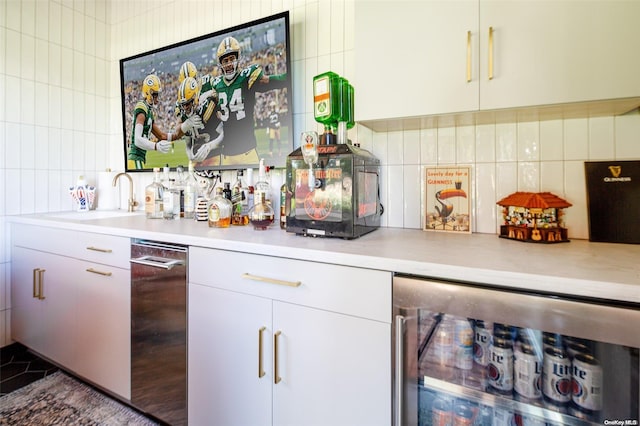 bar featuring white cabinetry, sink, wine cooler, and tasteful backsplash