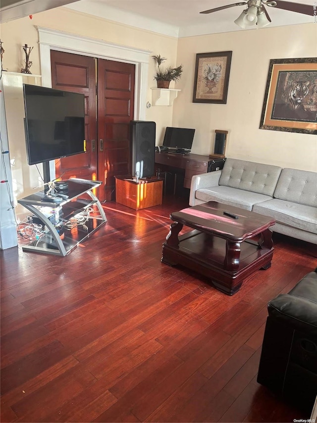 living room with wood-type flooring and ceiling fan