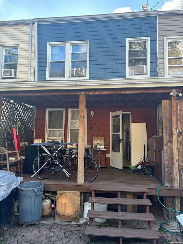 rear view of property featuring a wooden deck