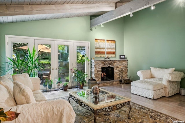 living room featuring hardwood / wood-style floors, a fireplace, lofted ceiling with beams, wood ceiling, and french doors