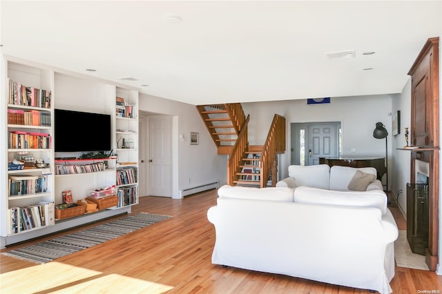 living room with light hardwood / wood-style floors and baseboard heating