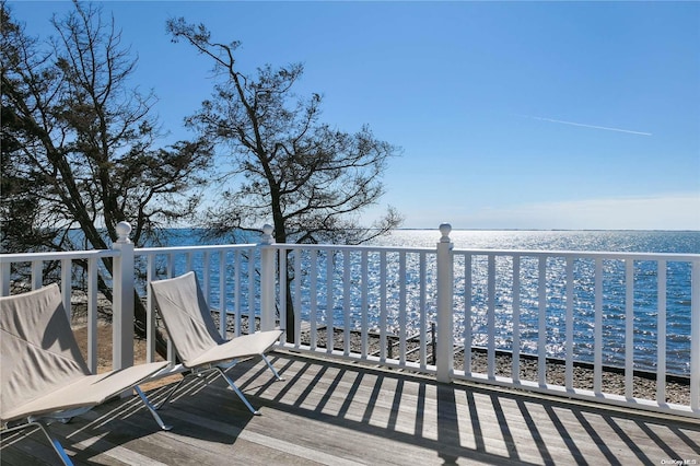 deck featuring a beach view and a water view