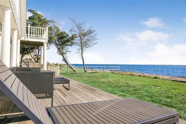 deck featuring a yard and a water view