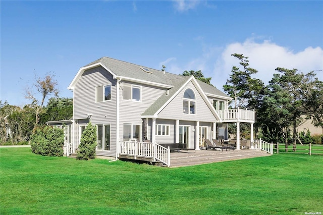 back of property featuring a lawn and a deck