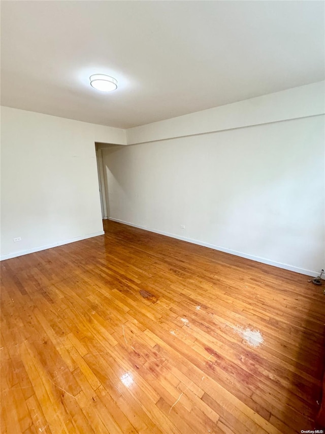 empty room with hardwood / wood-style flooring