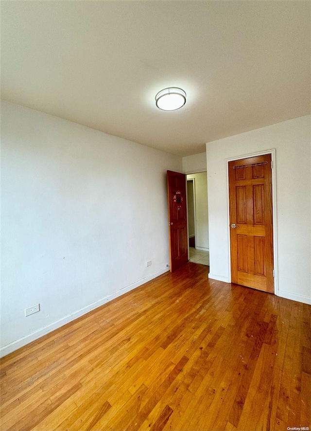 unfurnished room featuring wood-type flooring