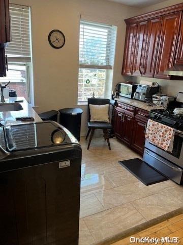 kitchen with stainless steel range with electric stovetop and sink