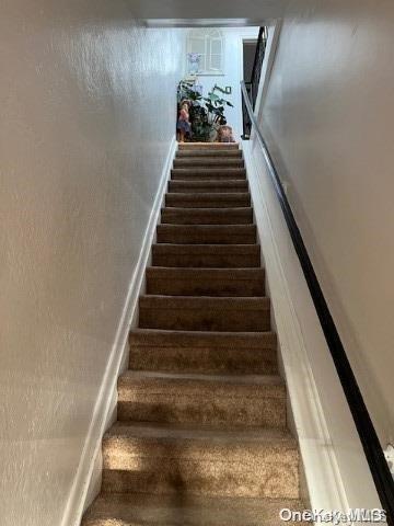 stairs with wood-type flooring